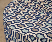 Upholstered In Shades Of Blue Round Ottoman