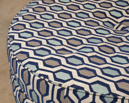 Upholstered In Shades Of Blue Round Ottoman