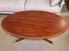 Henkel Harris Oval Banded Mahogany Cocktail Table with Brass Feet on Casters