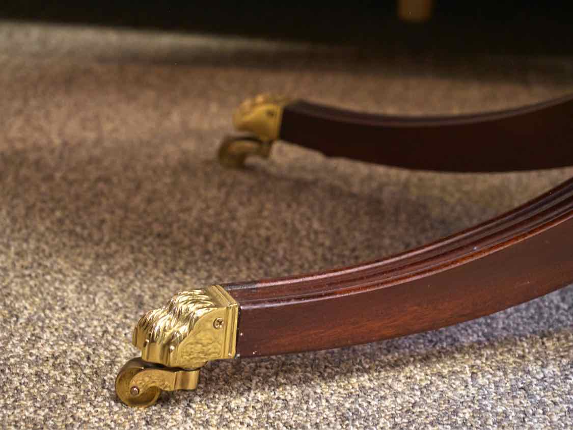 Henkel Harris Oval Banded Mahogany Cocktail Table with Brass Feet on Casters