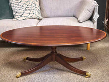 Henkel Harris Oval Banded Mahogany Cocktail Table with Brass Feet on Casters