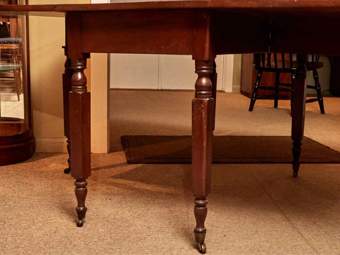 Antique Cherry Drop Leaf With Turned Legs On Casters Dining Table