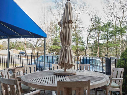 Outdoor Dining Set in Teak with 84" Round Dining Table, 8 Chairs & Umbrella