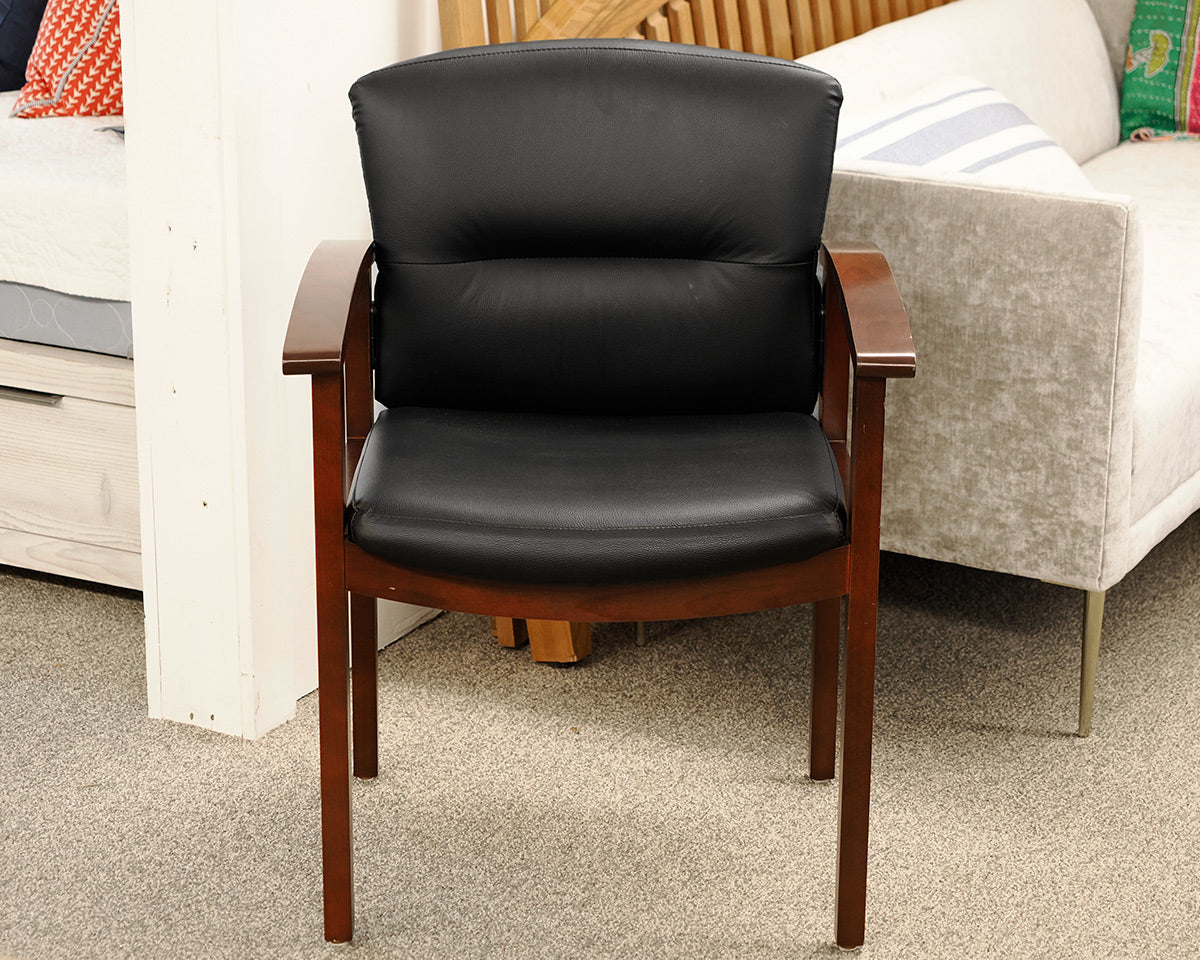 Black Faux Leather Office Chair on Dark Wood Frame