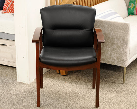 Black Faux Leather Office Chair on Dark Wood Frame