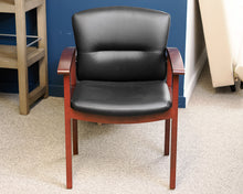 Black Faux Leather Office Chair on Dark Wood Frame