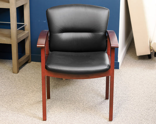 Black Faux Leather Office Chair on Dark Wood Frame