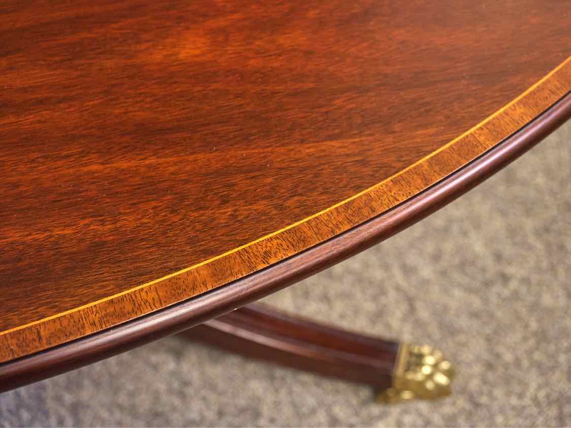 Henkel Harris Oval Banded Mahogany Cocktail Table with Brass Feet on Casters