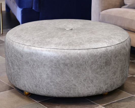 Norwalk Furniture Round Faux Leather Ottoman in Silver on Casters