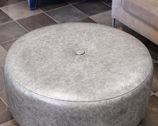 Norwalk Furniture Round Faux Leather Ottoman in Silver on Casters